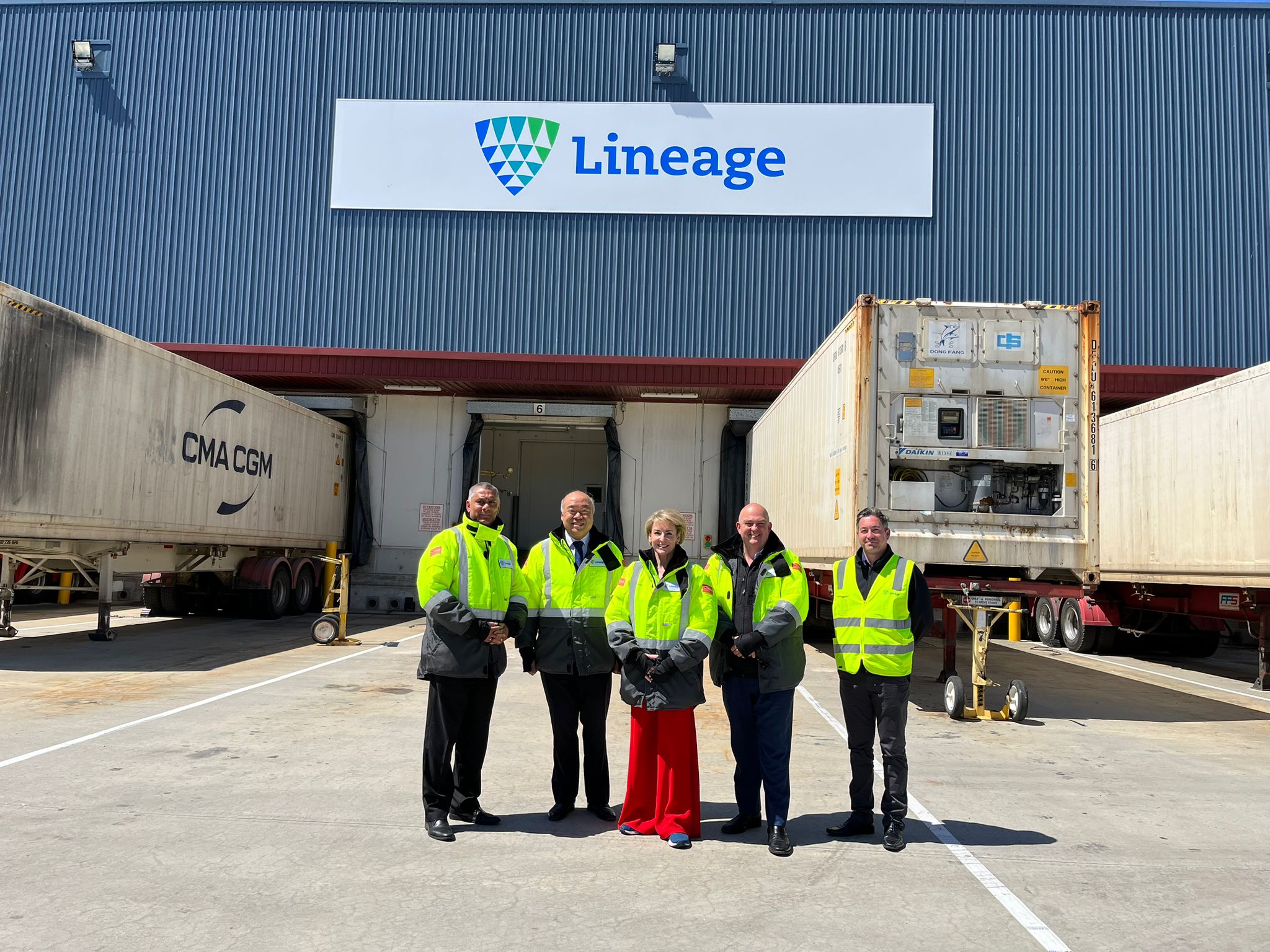 Michaelia Cash and four workers in high-visibility jackets outside a Western Australian cold-storage facility.